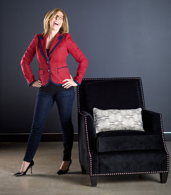 Jane in a red jacket beside a chair