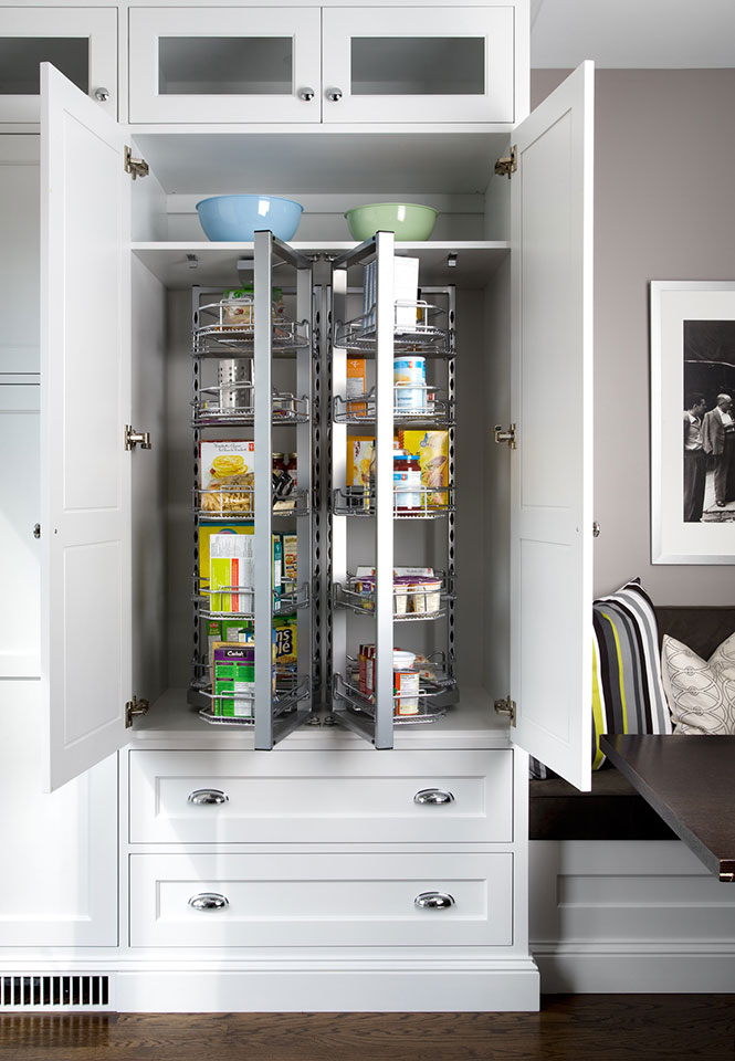 White kitchen pantry with doors open.