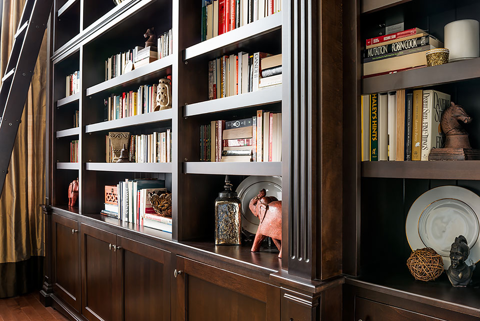 Dark wood bookshelf filled with books.