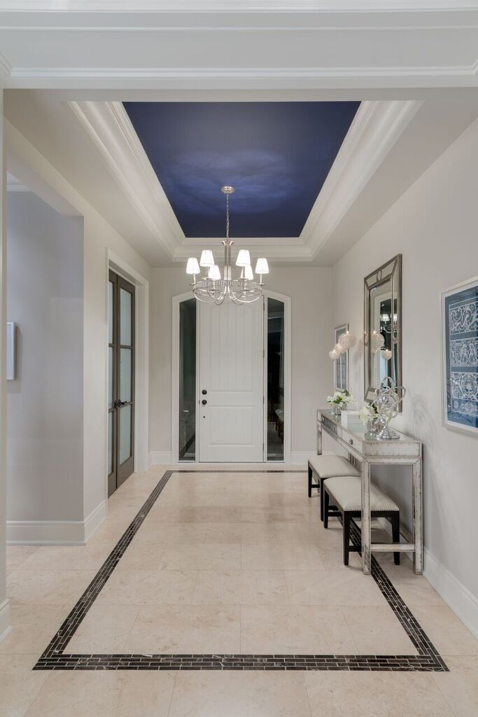 front door inside a condo with large white door and high ceilings