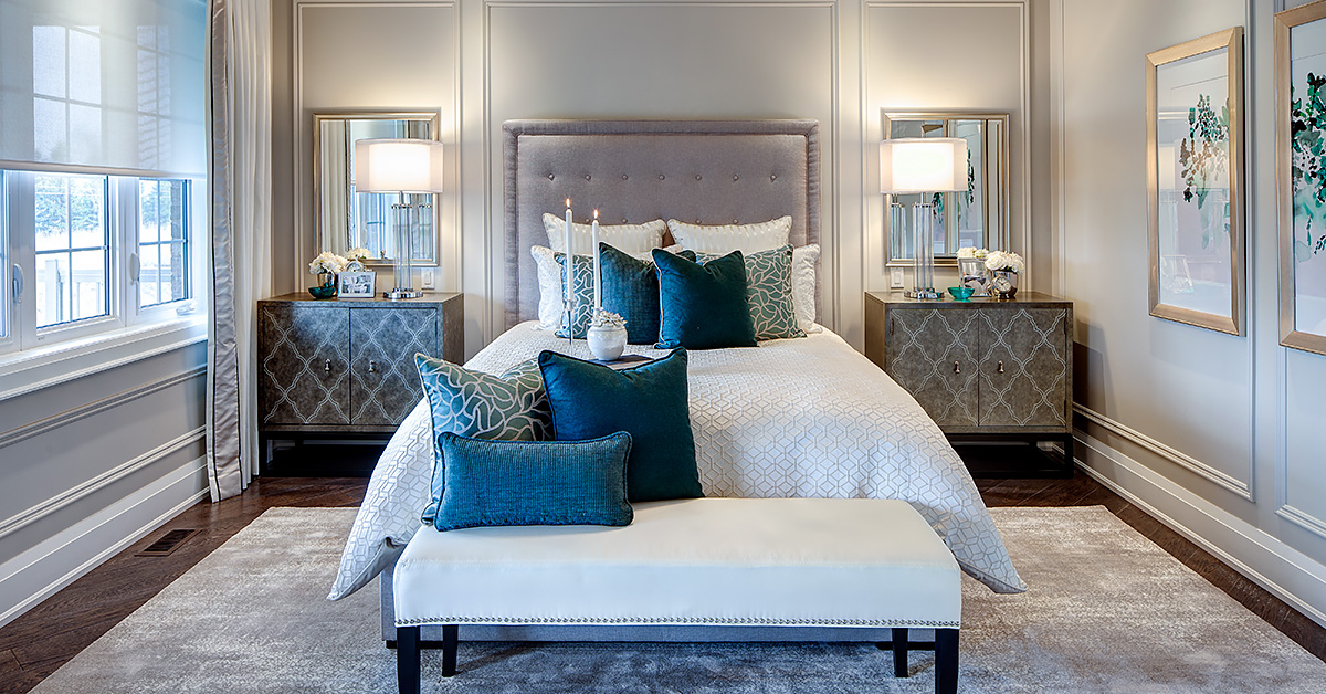 spacious bedroom with white bed and blue pillows