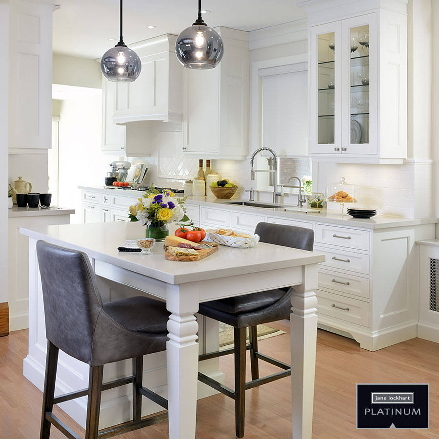 white kitchen after renovation white island stool two silver pendant lights