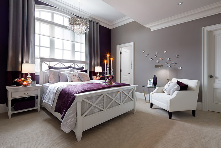 large bedroom window, bed with purple duvet
