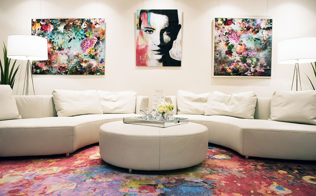 modern design with white sofas and ottoman and modern artwork on walls