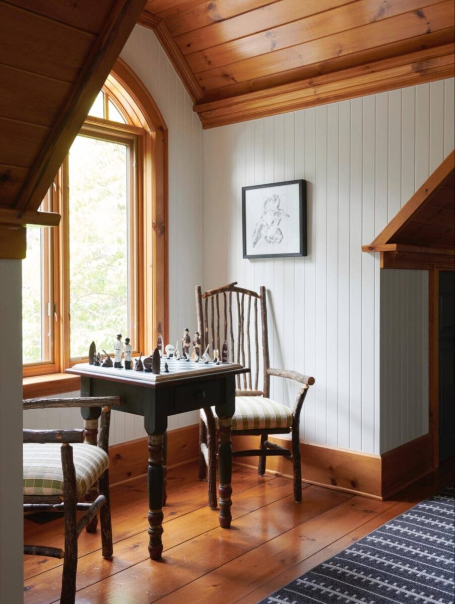 two vintage chairs and side table by window in cottage