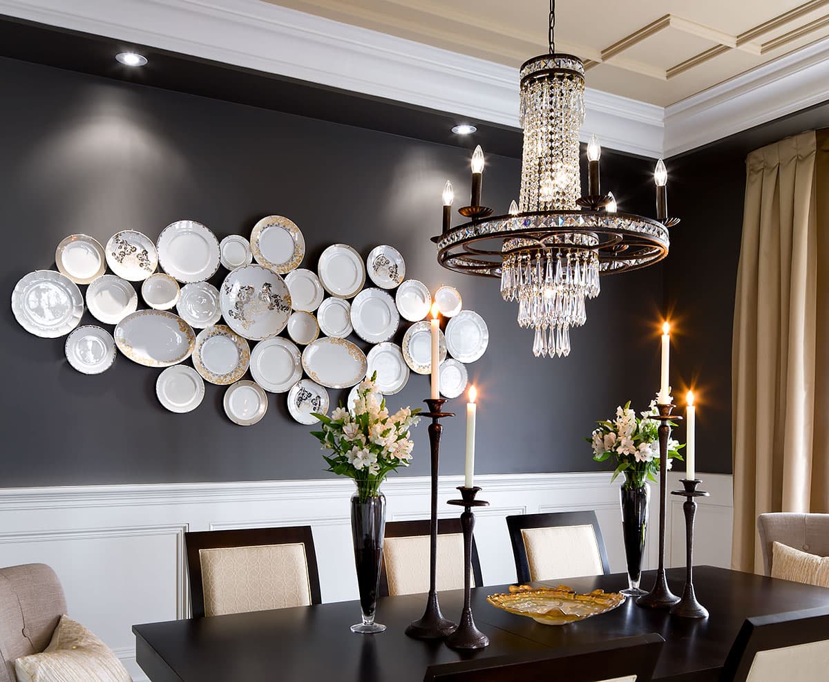 plates on wall in dining room, 4 lit candles, chandelier