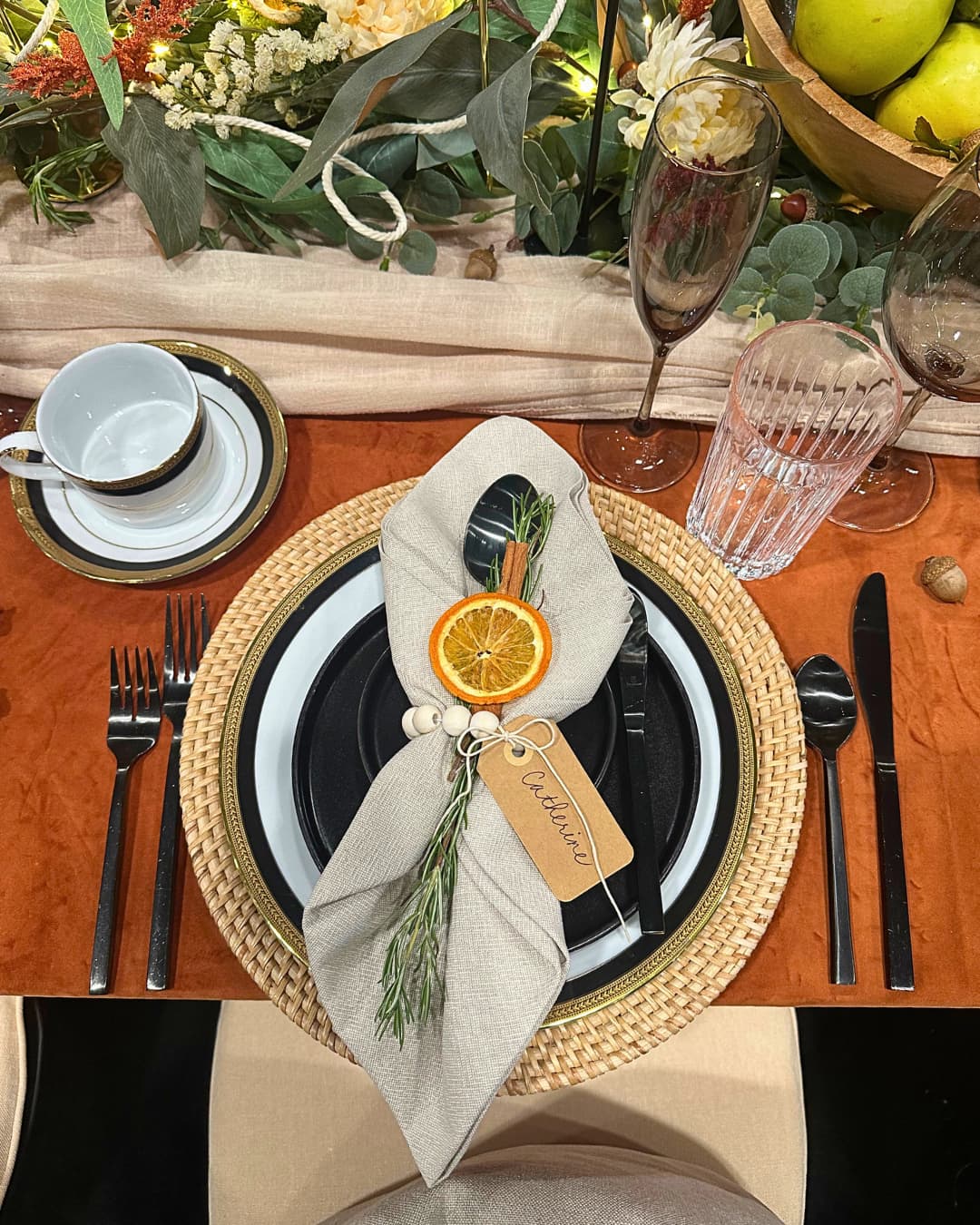 festive napkin rings with dried orange slice, rosemary and name tag