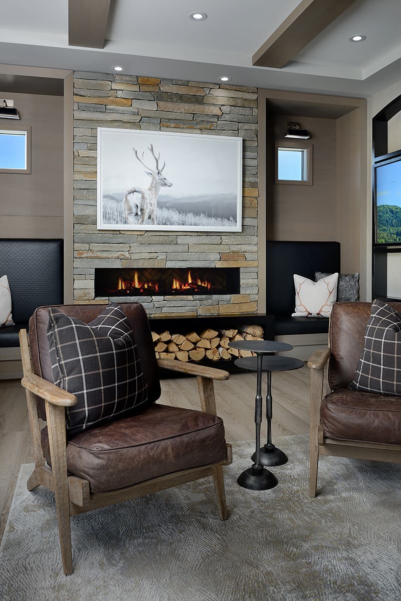 brown leather chairs and fireplace with firewood