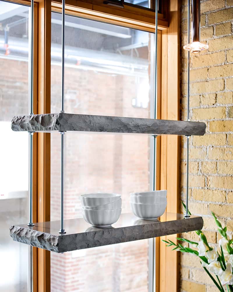 Suspended conrete shelf in front of bright window