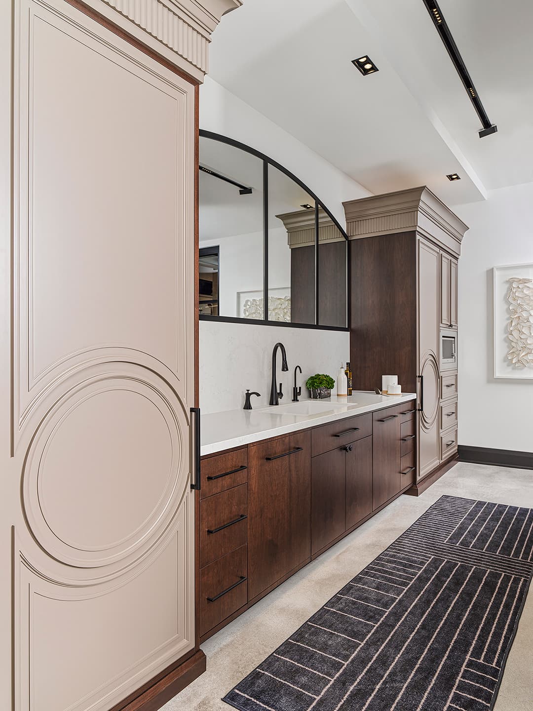 Integrated fridge and freezer with white countertop and sink and mirror