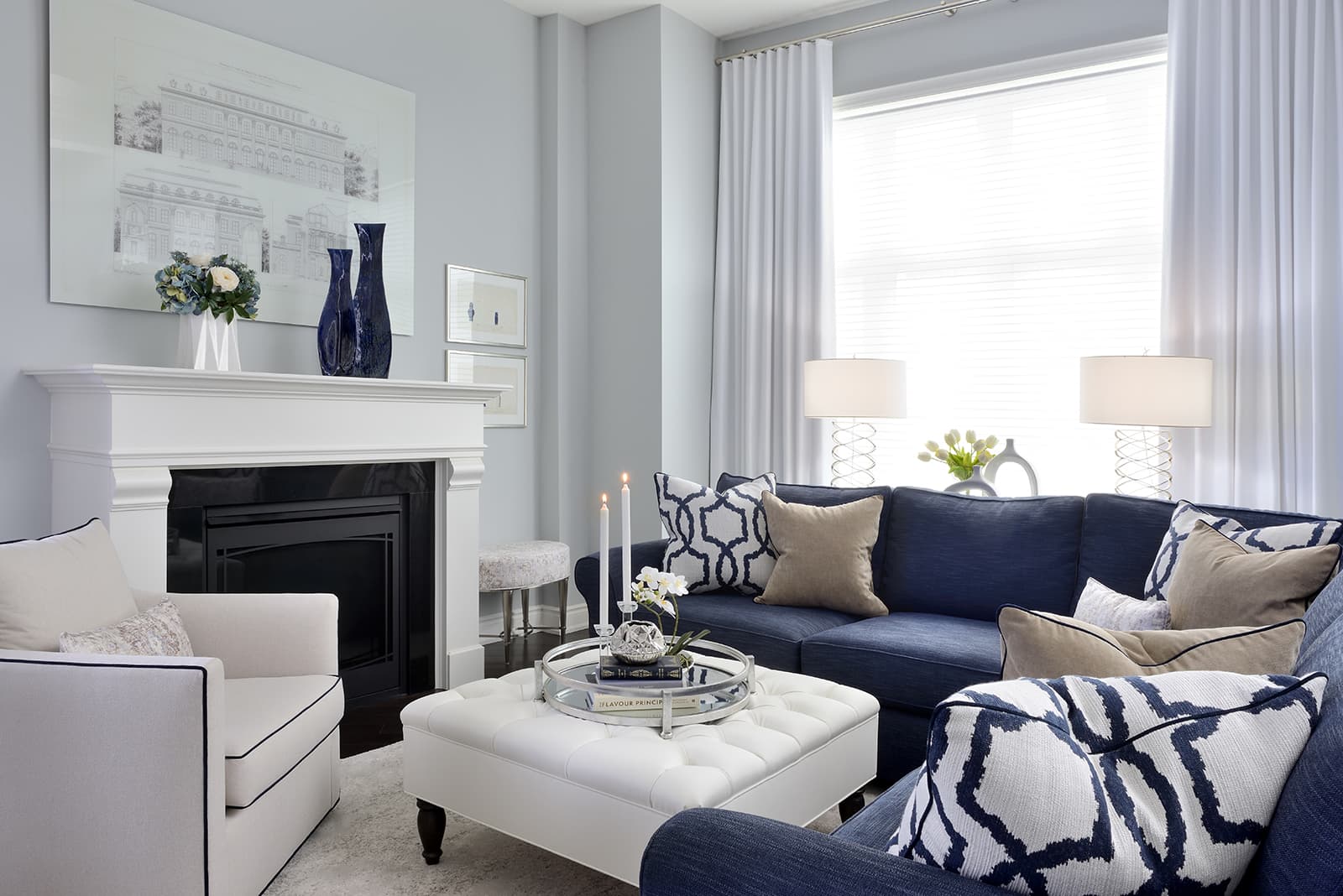 blue sofa white ottoman white lounge chair white fire place