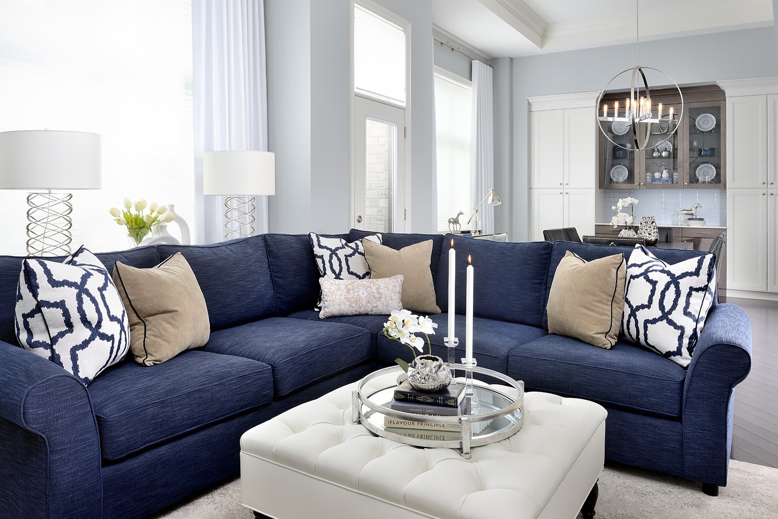 blue sofa white ottoman two white lampshades