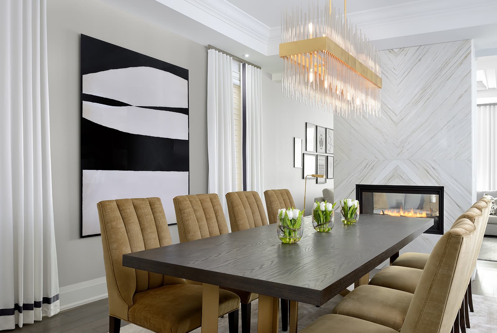 dining room table with 8 seats and white fireplace feature wall