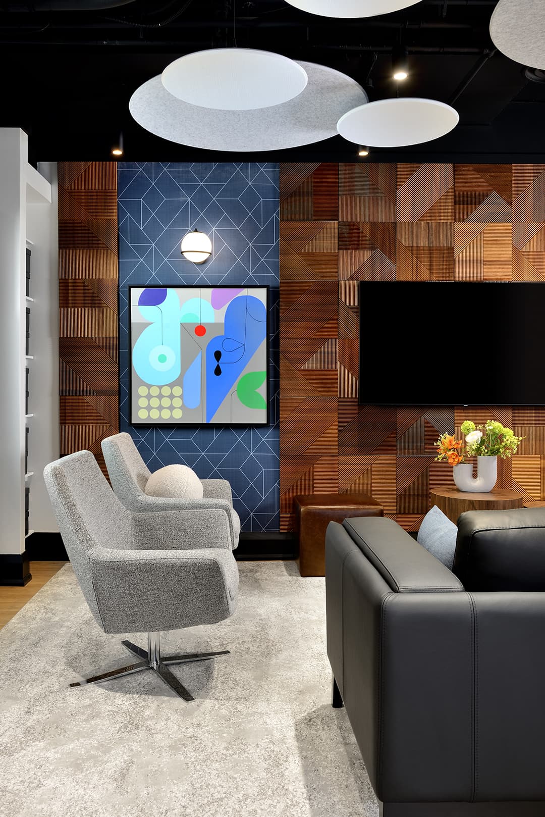 two lounge chairs, modern artwork on wall