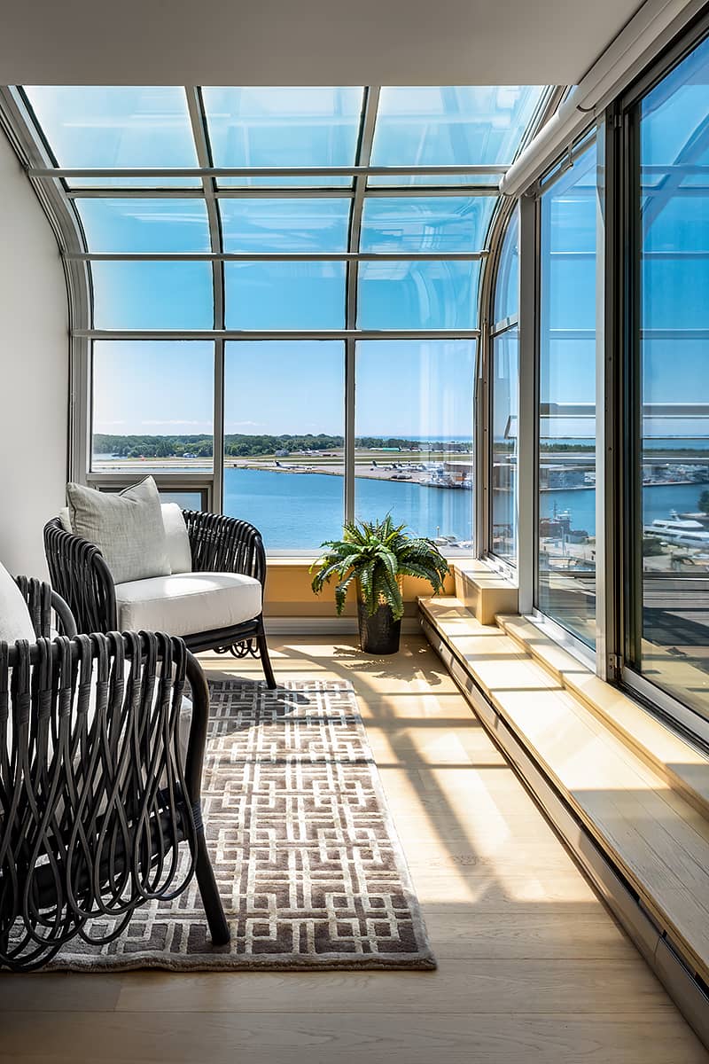 bright enclosed sunroom looking out to Lake Ontario in Toronto