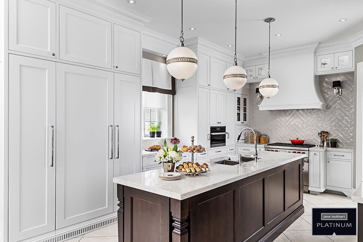 Modern kitchen with wall of white cabinetry and island with white marble countertop