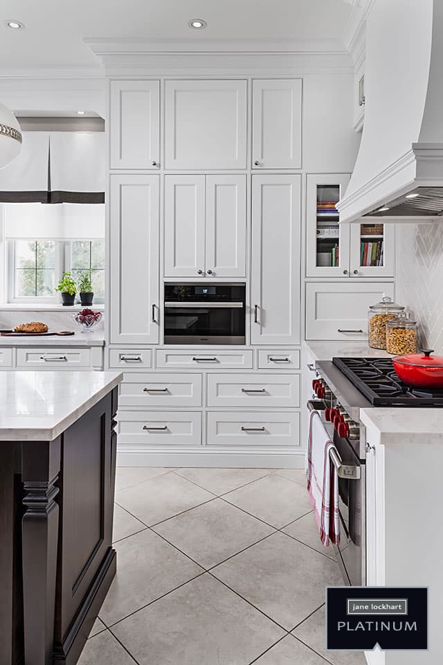 white kitchen cabinetry with built-in microwave and gas stove Jane Lockhart Design