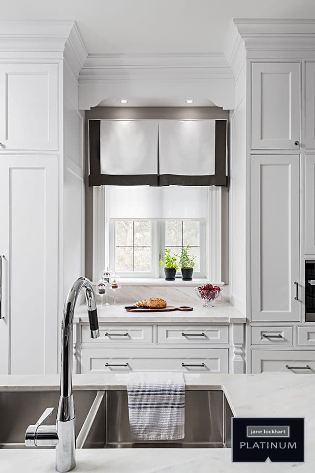 Stainless steel kitchen faucet and white marble countertop