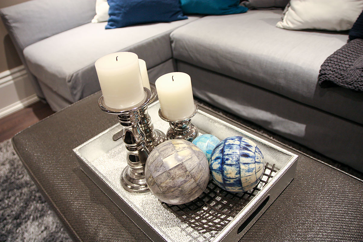 3 candles, two decorative balls on a tray