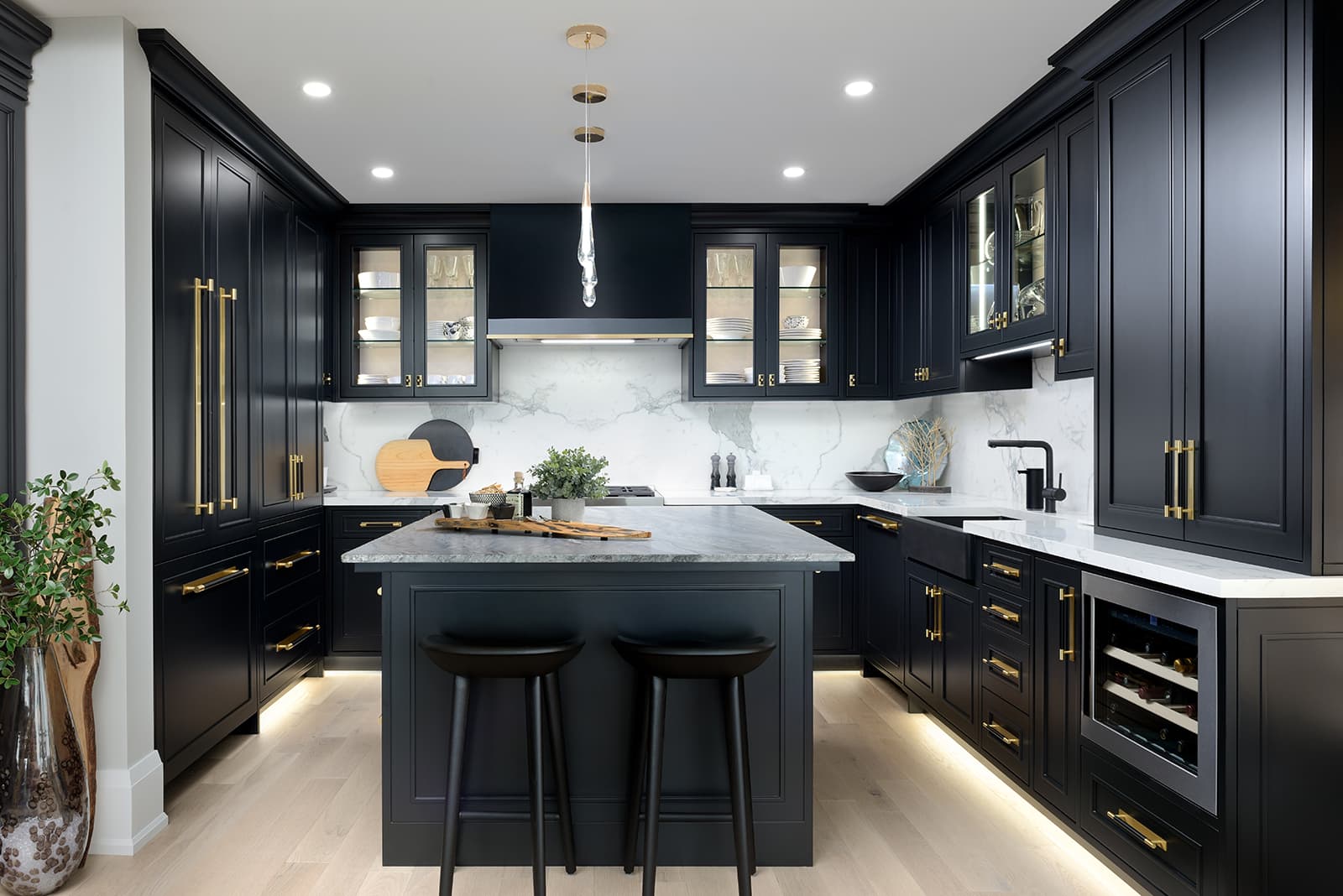 black cabinetry with island in centre of room