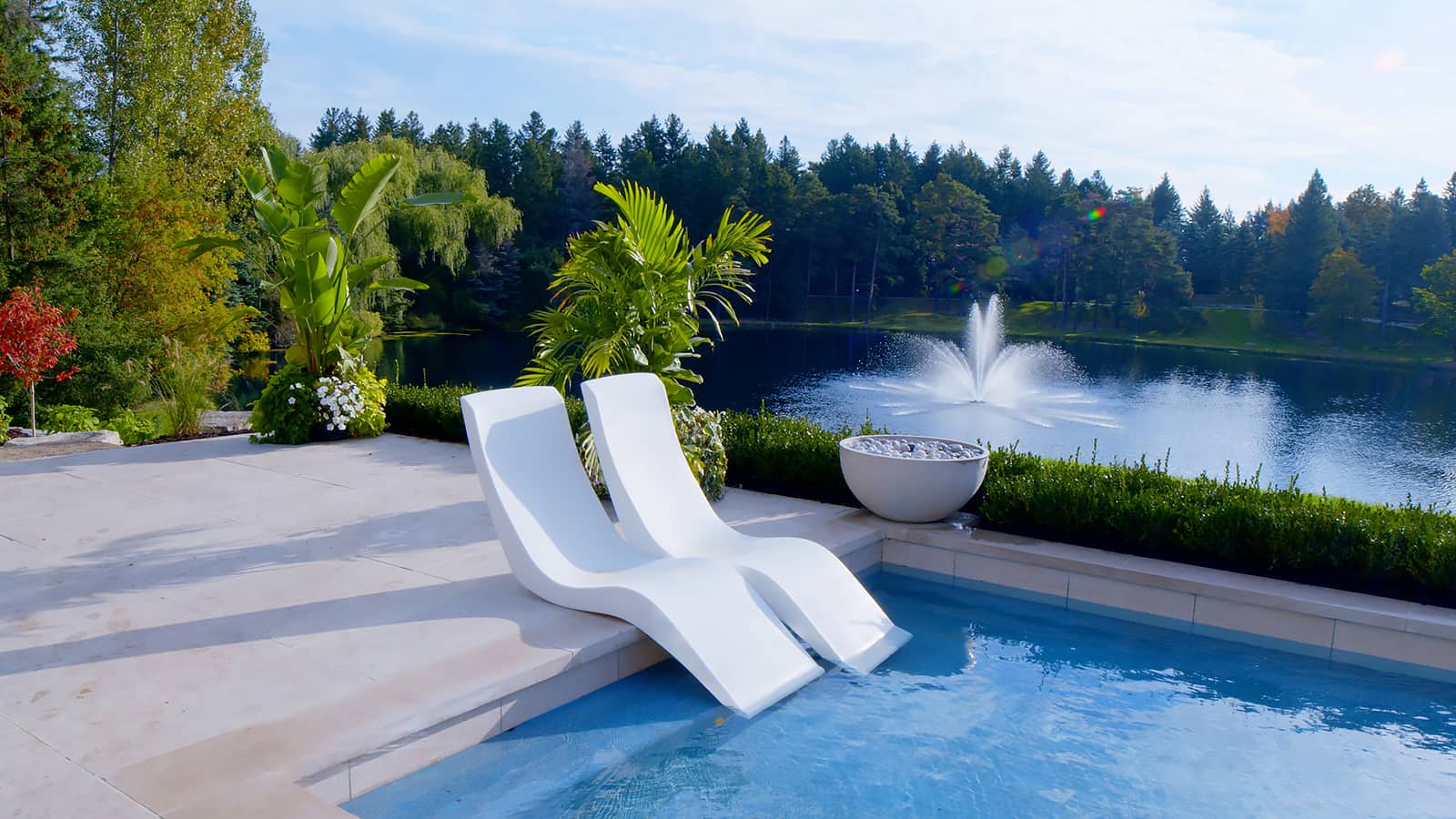 white chaise chairs beside pool