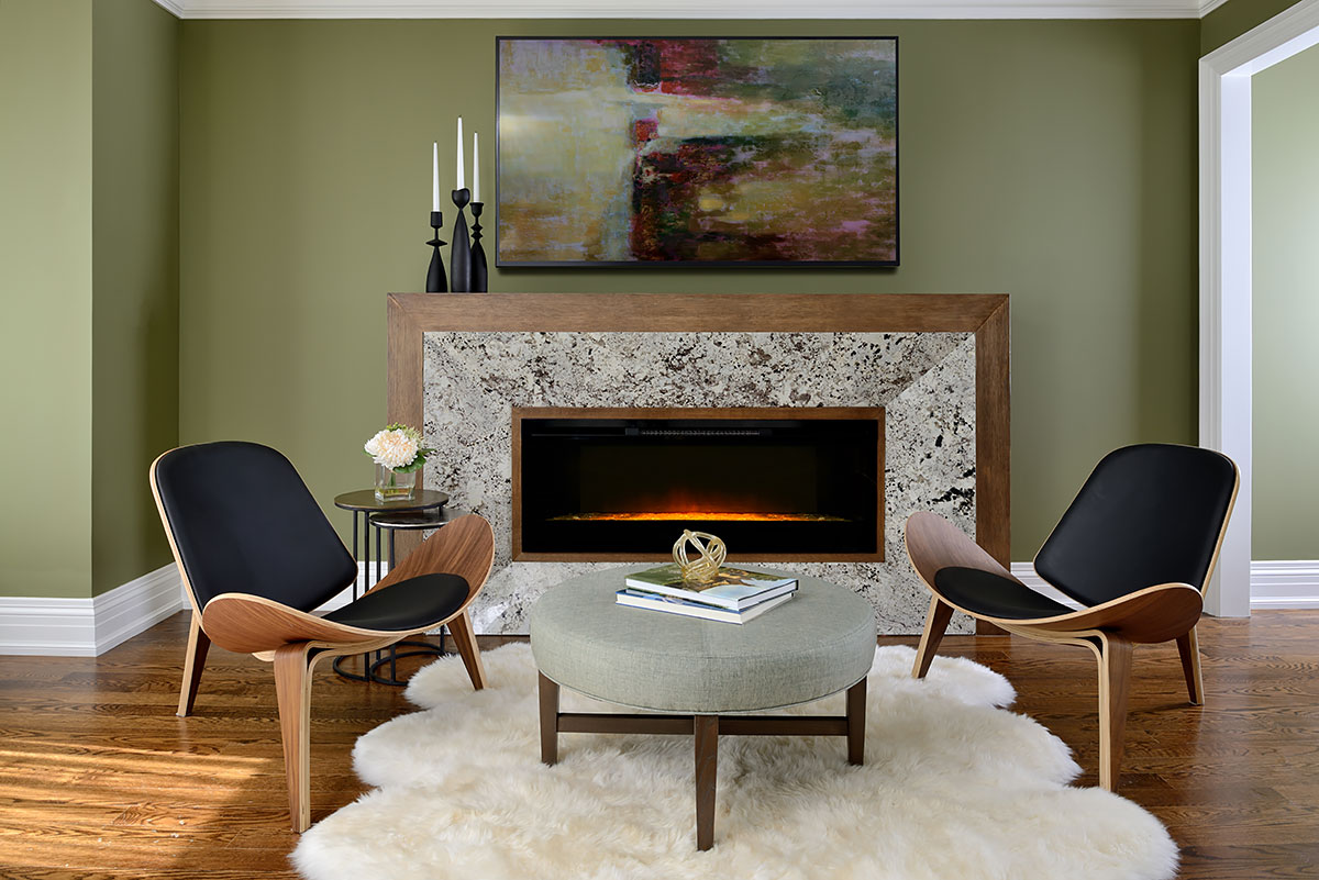 Fireplace, two chairs, green walls