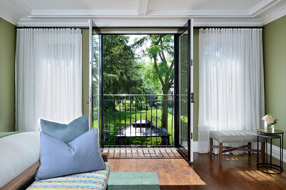 French doors open with blue pillows on sofa