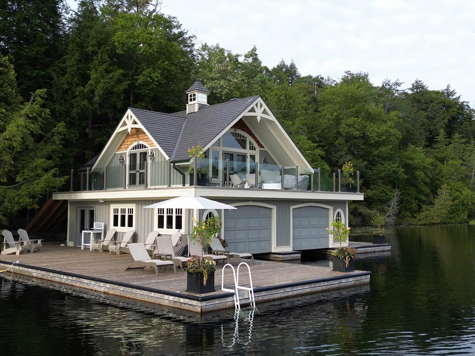 Muskoka boathouse, dock, two Muskoka chairs