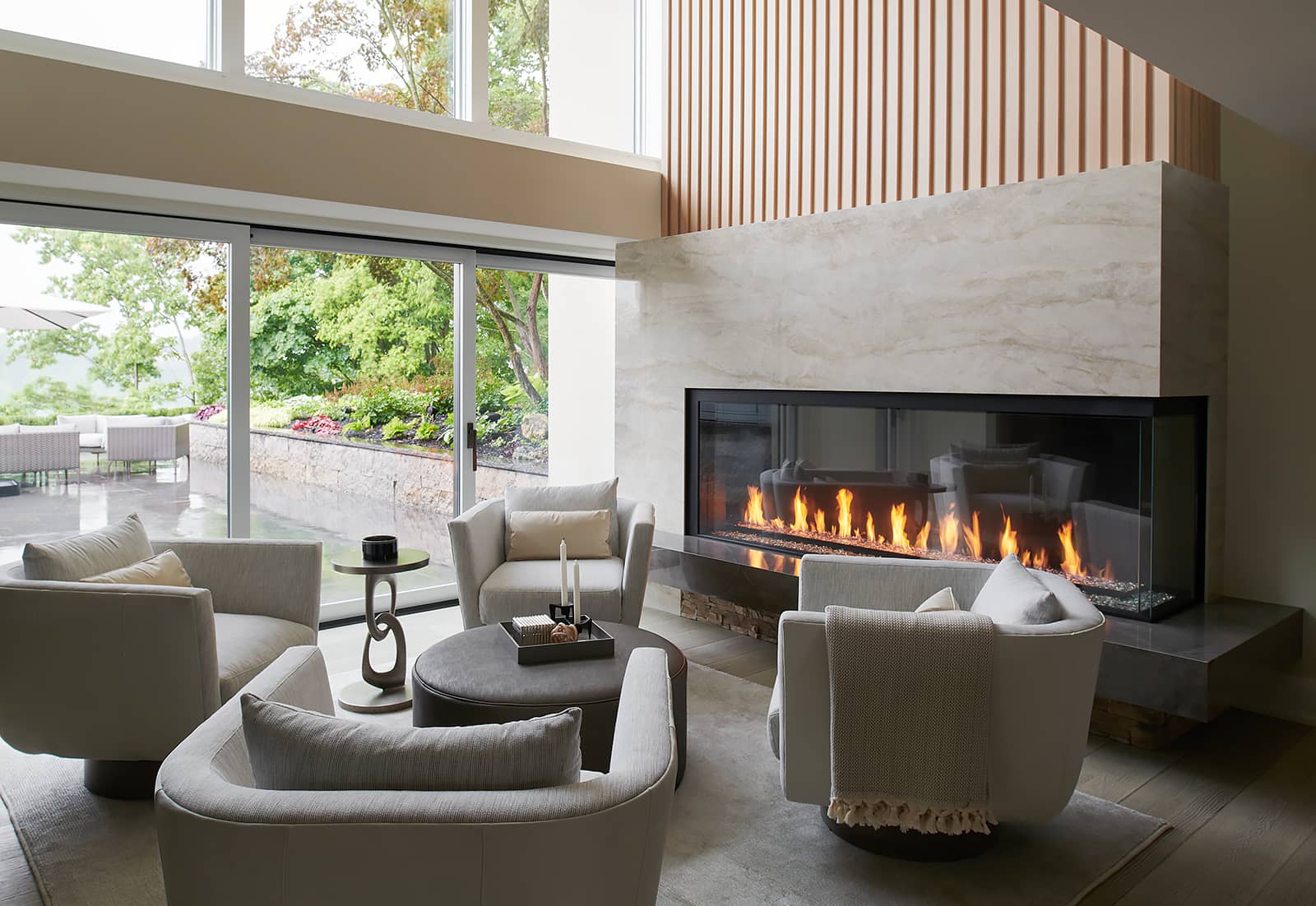 family room with 4 swivel chairs, coffee table, large fireplace