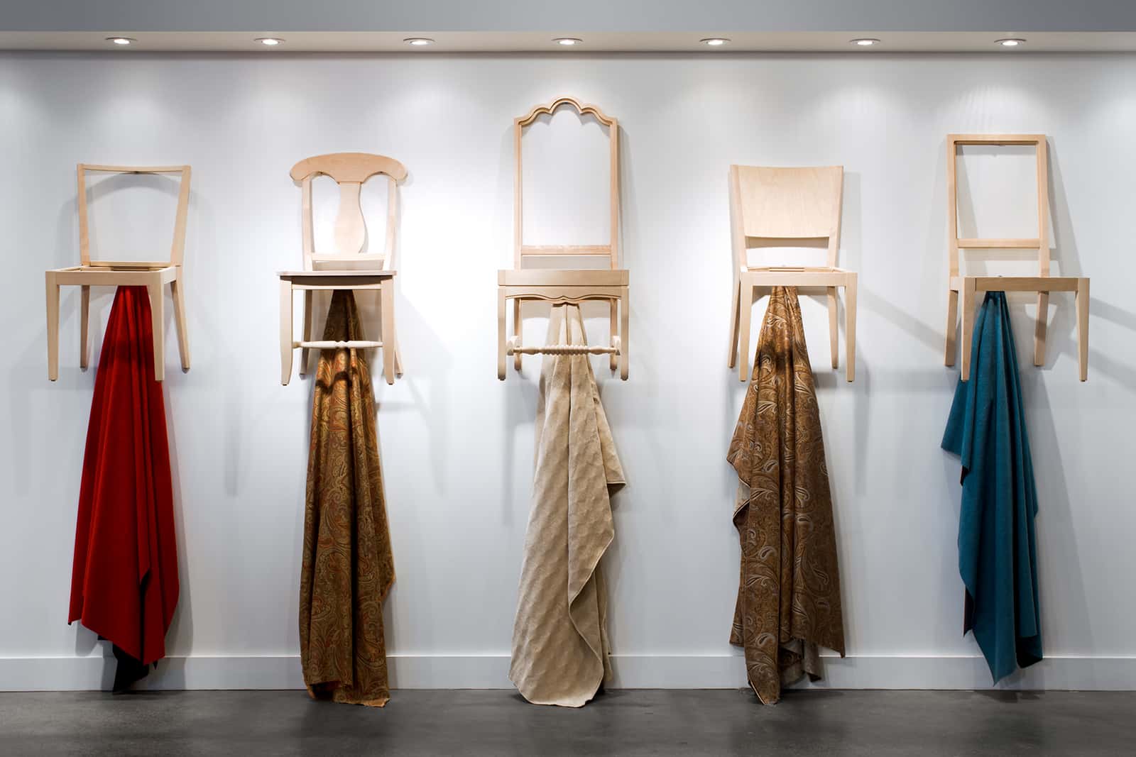 Various chairs hanging on wall